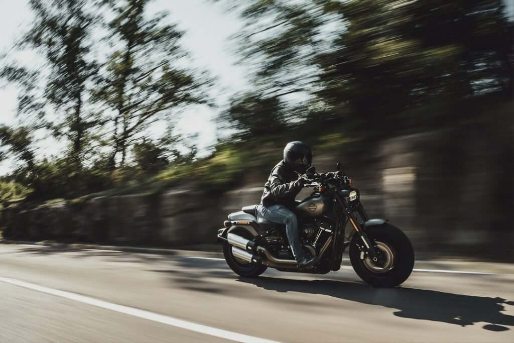 Man going fast on a harley davidson motorcycle